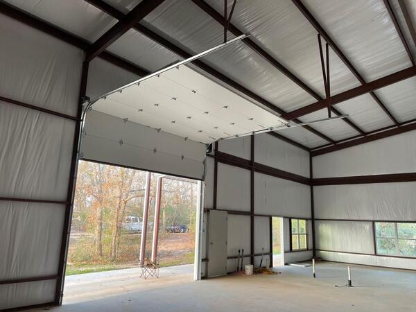Commercial overhead garage door inside steel warehouse building