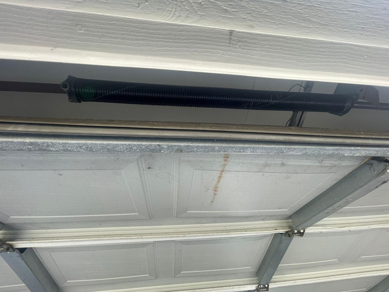 New torsion spring installed above garage door